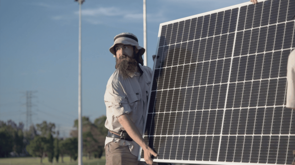 Solar system installer in Instyle Solar uniform holding a solar panel